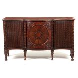 AN UNUSUAL 18TH CENTURY AND LATER SERPENTINE SHAPED MAHOGANY IRISH STYLE SIDEBOARD with reeded