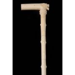 A 19TH CENTURY CARVED IVORY WALKING CANE the hawthorn simulated segmented stick of tapered form with