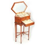 A FINE EARLY 20TH CENTURY FIGURED SATINWOOD HEXAGONAL MANICURE CABINET with carved gilt mouldings