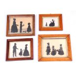 A SELECTION OF FOUR 19TH CENTURY SILHOUETTES depicting family group scenes in glazed moulded maple