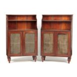 A PAIR OF REGENCY MAHOGANY WATERFALL BOOKCASES each with stepped fitted shelves above a pair of