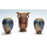 A PAIR OF CROWN DEVON FANTAZIA OVOID VASES decorated in vibrant leafing flower sprays and birds on a