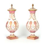 A PAIR OF LATE 19TH CENTURY FRENCH PORCELAIN VASES AND COVERS WITH ORMOLU FINIALS of swirled