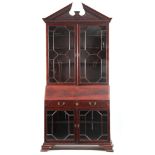 AN UNUSUAL MID 18TH CENTURY MAHOGANY ARCHITECTURAL BUREAU BOOKCASE having a floral carved
