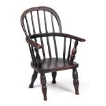 A 19TH CENTURY STAINED ASH AND ELM CHILD'S WINDSOR CHAIR with hooped back and spindle supports above