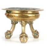 A 19TH CENTURY BRASS WINE COOLER of circular form with lead liner; standing on three ball and claw