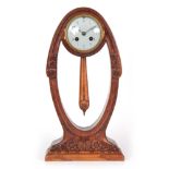 A STYLISH OAK CASED ART NOUVEAU MANTEL CLOCK signed to the base by the French designer Georges de