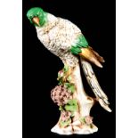 A 19TH CENTURY DERBY FIGURE OF A PARROT perched on a florally encrusted and leaf work stump base -