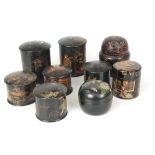 A SELECTION OF EIGHT 19TH CENTURY ORIENTAL BLACK LACQUER AND CHINOISERIE CYLINDRICAL LIDDED