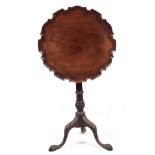 A GEORGE III MAHOGANY TILT TOP TRIPOD OCCASIONAL TABLE with pie crust top above a tapering turned
