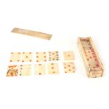 A 19TH CENTURY BONE PRISONER OF WAR CASED SET OF PLAYING CARDS with etched figure scenes to the