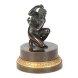 AN UNUSUAL 19TH CENTURY BRONZE INKWELL depicting a bronze sculpture of a nude lady revealing a