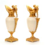A FINE PAIR OF 19THCENTURY FRENCH WHITE MARBLE AND GILT ORMOLU EWERS the shouldered tapering