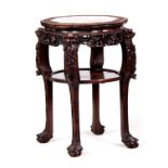 A 19TH CENTURY PROFUSELY CARVED CHINESE HARDWOOD CIRCULAR JARDINIERE STAND with marble inset top and