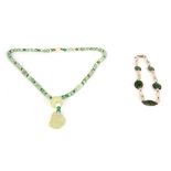 TWO CHINESE JADE AND SILVER NECKLACES one with carved pendantand 64cm long neck chain, the other