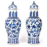 A LARGE PAIR OF 19TH CENTURY CHINESE BLUE AND WHITE LIDDED VASES with domed lids surmounted by Foo