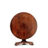 A WILLIAM IV ROSEWOOD CENTRE TABLE IN THE MANNER OF GILLOWS with beaded edge circular top above a