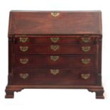 A GOOD EARLY GEORGE III LANCASHIRE CHIPPENDALE MAHOGANY BUREAU the hinged fall with carved border