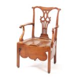 AN 18TH CENTURY COUNTRY MADE ELM CHIPPENDALE STYLE COMMODE ARMCHAIR with shaped top rail above a