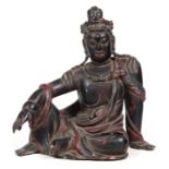 A LARGE ORIENTAL CARVED LACQUERED WOOD FIGURE OF GUANYIN in a seated pose with red and gilt