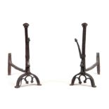 A LARGE PAIR OF EARLY CAST IRON FIRE DOGS with punch decoration having hooks to the front;