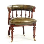 A 19TH CENTURY WALNUT DESK CHAIR with green leather upholstery and barrel back supported by turned