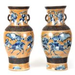 A PAIR OF 19TH CENTURY CHINESE CRACKLE GLAZE VASES with fighting scenes of blue and white figures on