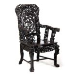 A 19TH CENTURY CHINESE HARDWOOD DRAGON ARMCHAIR the shaped back carved with dragons amongst clouds