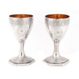 A FINE PAIR OF LATE 18TH CENTURY SILVER AND GILT GOBLETS having bright-cut foliate engraved