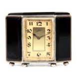 AN ART DECO SWISS SILVER AND BLACK ONYX BOUDOIR CLOCK SIGNED 'MILDO' the silver case set with five