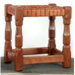 A ROBERT 'MOUSEMAN' THOMPSON JOINT STOOL with interlaced strapwork hide top above adzed faceted legs