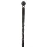 A 19TH CENTURY IRISH BOG OAK WALKING CANE with turned reeded handle and bone collar on a tapering