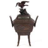 A LARGE JAPANESE BRONZE CENSOR with eagle mounted pagoda-shaped lid having pierced holes above a