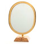 A VINTAGE PATEK PHILIPPE SHOP MIRROR the brass oval frame with pivoted adjustment mounted on a
