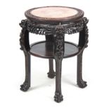 A 19TH CENTURY CHINESE CARVED HARDWOOD STAND having an inset pink marble top within a carved bead