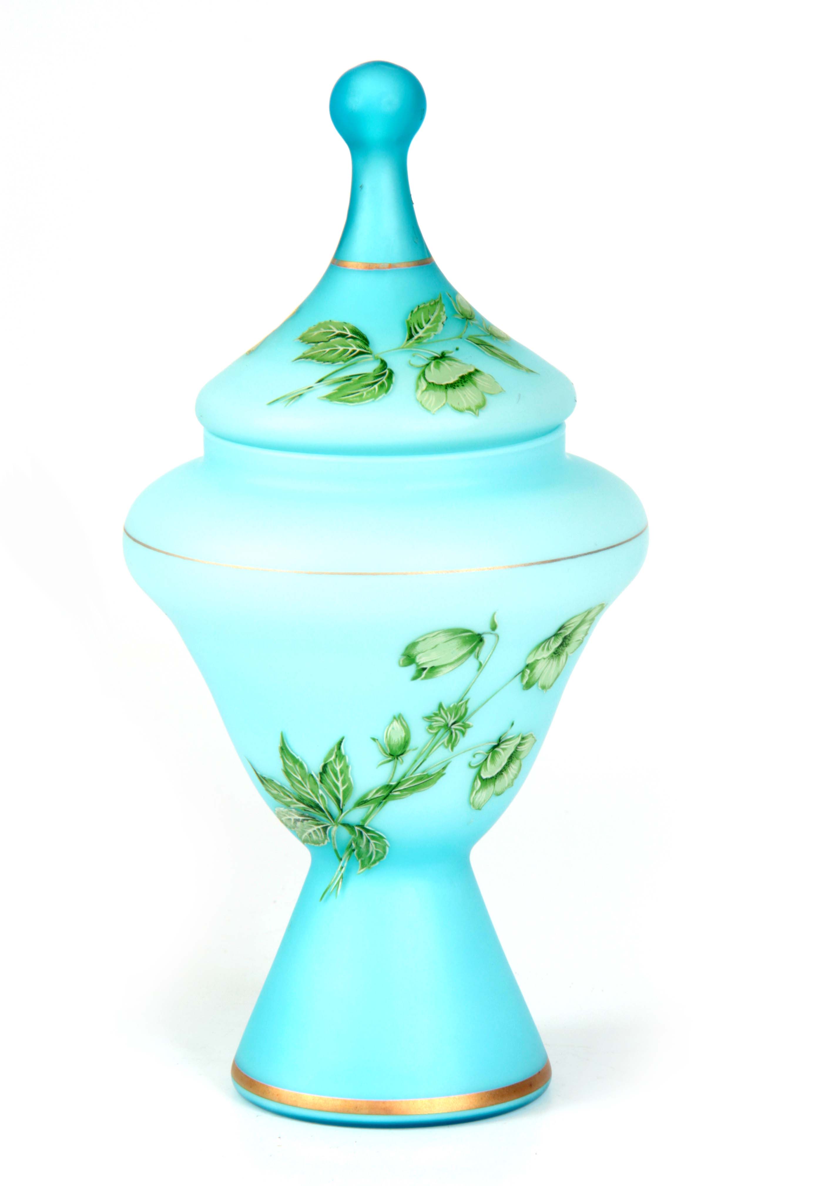 A 19TH CENTURY BLUE GLASS AND OVERLAID ENAMEL VASE AND COVER with floral decoration 28.5cm high