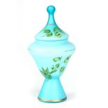 A 19TH CENTURY BLUE GLASS AND OVERLAID ENAMEL VASE AND COVER with floral decoration 28.5cm high