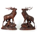 A PAIR OF 19TH CENTURY CARVED LINDEN WOOD BLACK FOREST SCULPTURES OF STAGS mounted on naturalistic
