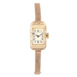A LADIES ART DECO 9ct GOLD WRISTWATCH on 9ct gold bracelet, the rectangular case with fine foliate