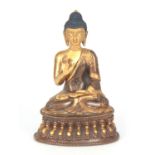 AN EARLY GILT BRONZE SEATED BUDDHA having gilt highlights 14.5cm high.