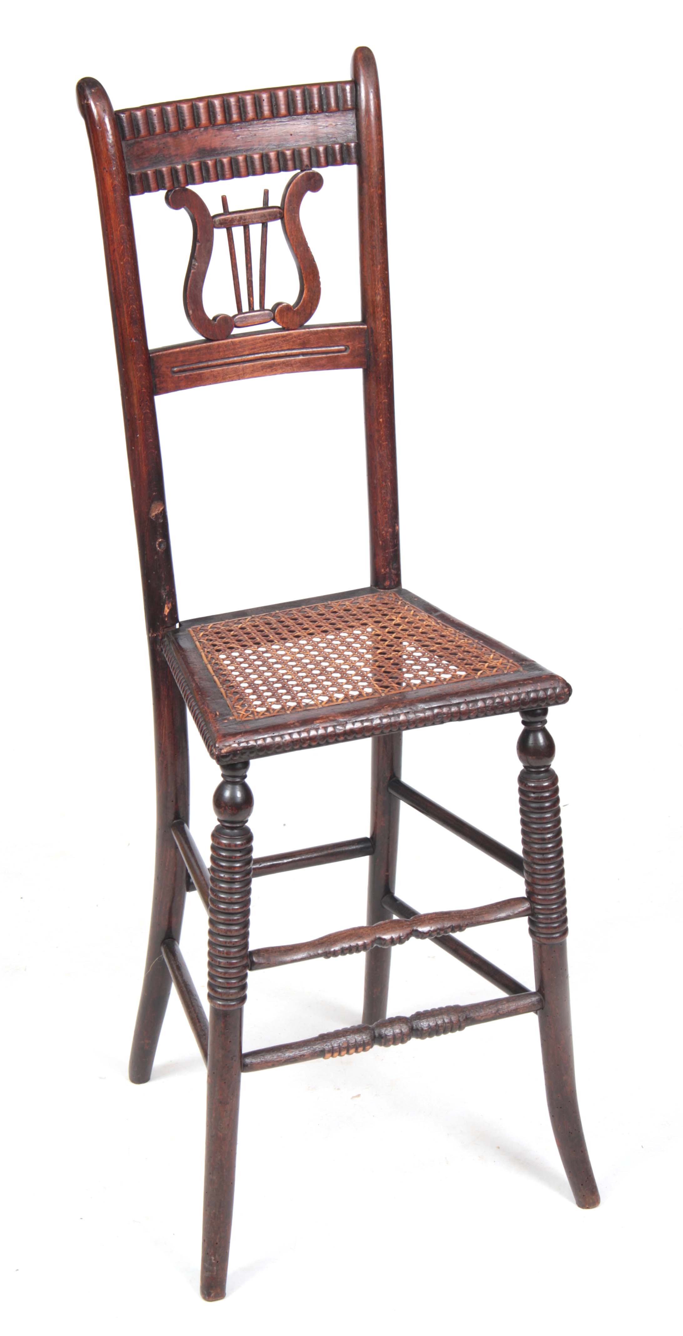 A 19TH CENTURY LATE REGENCY SIMULATED ROSEWOOD STAINED BEECH CHILD'S CORRECTION CHAIR with lyre-