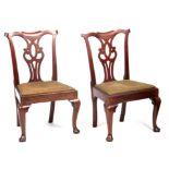 A PAIR OF MID 18TH CENTURY MAHOGANY SIDE CHAIRS with shaped top rails above open pierced backsplats,