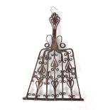 AN 18TH CENTURY IRONWORK TRIVET with heart and scrollwork decoration and handle, supported on