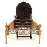 AN EARLY 18TH CENTURY ENGRAVED BRASS AND CAST IRON SERPENTINE FIRE GRATE with figural moulded