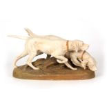 A LATE 19TH CENTURY ROYAL DUX BOHEMIA GROUP OF TWO GUN DOGS ivory ground and modelled as a pointer