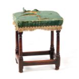 A 17TH CENTURY UPHOLSTERED WALNUT JOINT STOOL with ring turned tapering legs joined by under