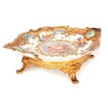 A 19TH CENTURY LIMOGES STYLE ORMOLU MOUNTED CENTREPIECE with rococo style gilt work border, the