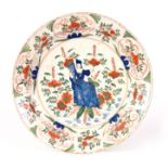 AN EARLY 18TH CENTURY POLYCHROME DELFT CHARGER decorated with a lady to the centre surrounded by