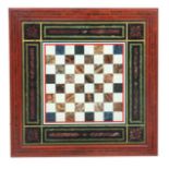 A 19TH CENTURY FRAMED PAINTED CHESS BOARD SLATE TABLE TOP simulating coloured marbles within a