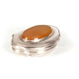 A GEORGIAN SCOTTISH SNUFF BOX with oval amber stone inset to the lid above shaped sides - unmarked